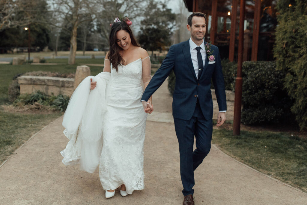 bride and groom walking holding hands at bendooley estate wedding