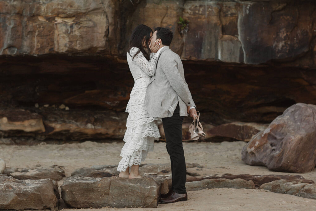 bride kissing groom portrait byron bay beach wedding