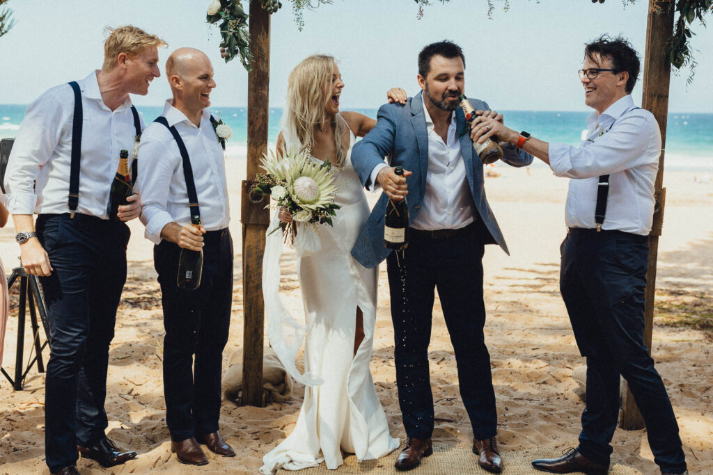 groom drinking champagne whale beach wedding