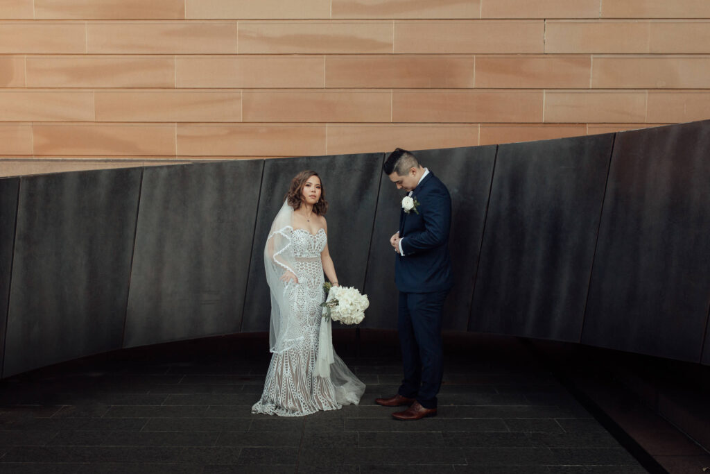 bride and groom posing at nsw art gallery wedding
