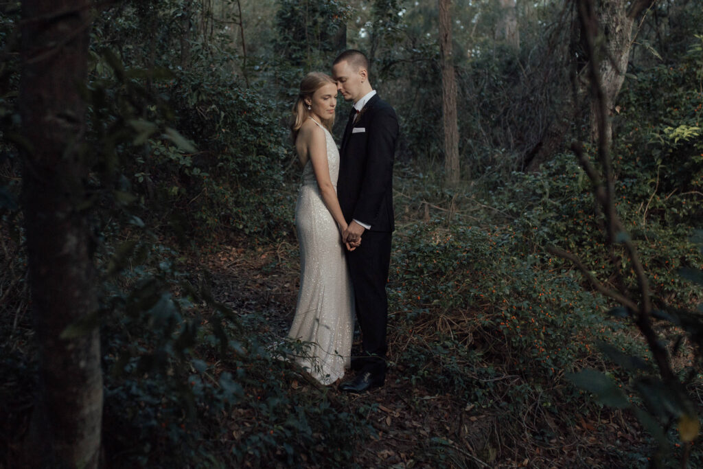 bride and groom posing at byron bay hinterland wedding