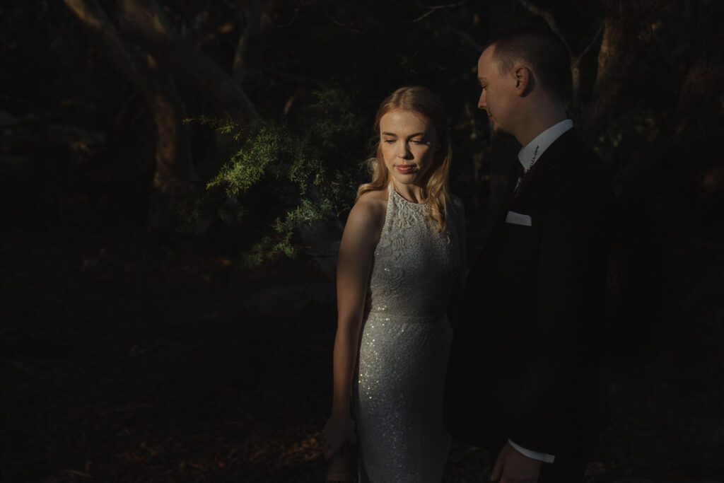 bride and groom posing at rainforest wedding