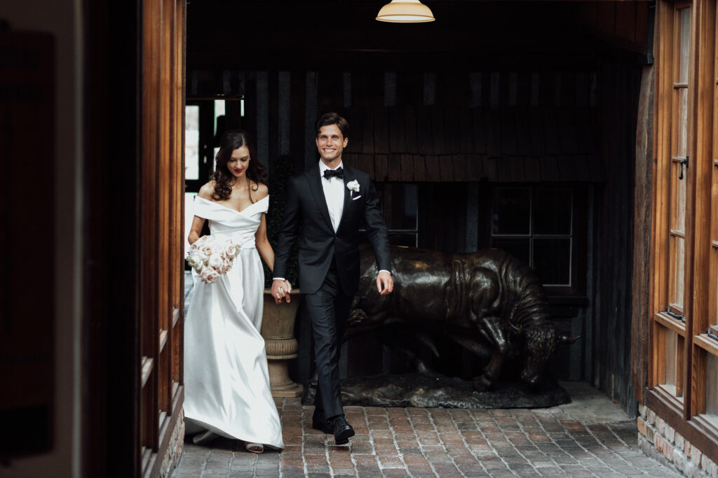 bride and groom walking holding hands at byron bay wedding