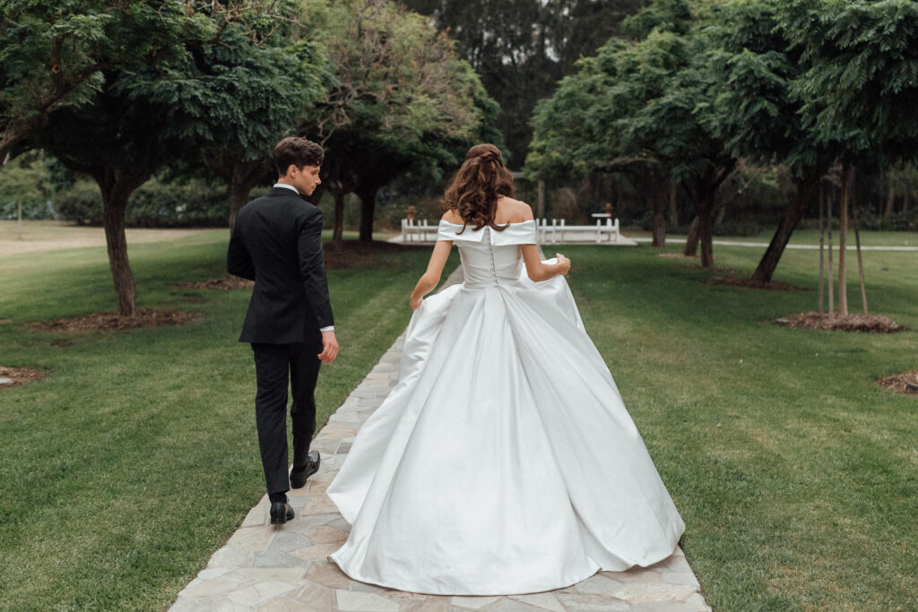 bride and groom walking on path in the sunshine coast hinterland