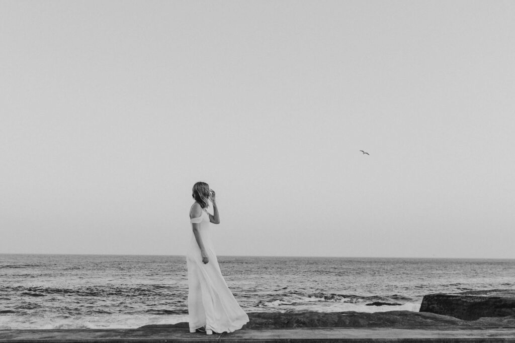 bride walking near ocean