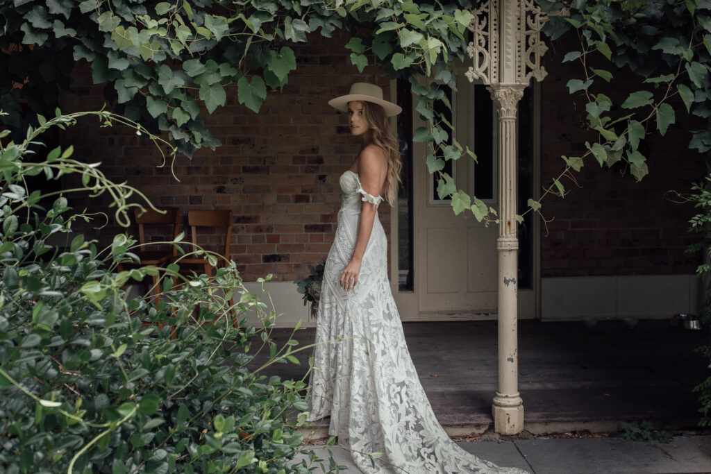 bride walking under vine at country wedding