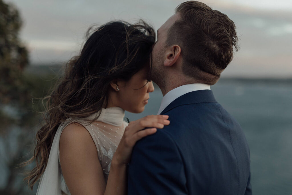 groom kissing bride at byron bay wedding