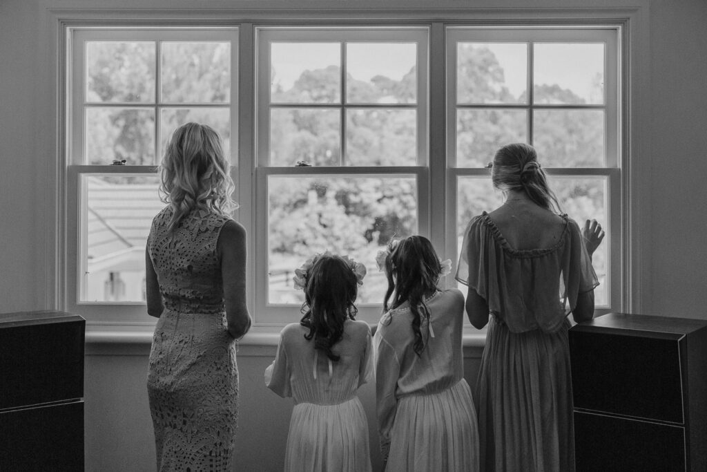 wedding guest standing at window at byron bay hinterland wedding