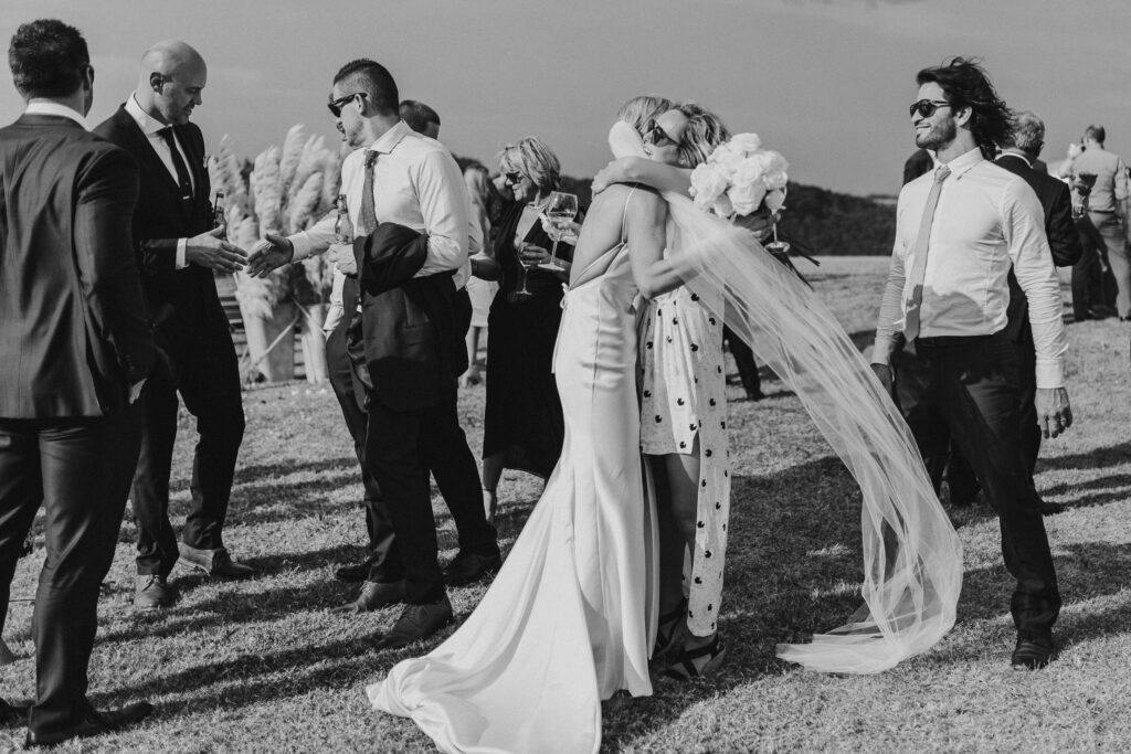wedding guest hugging at the orchard estate wedding