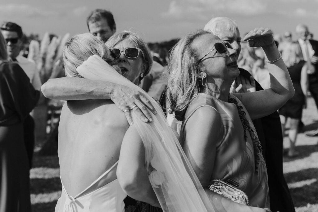 wedding guests hugging at the orchard estate wedding