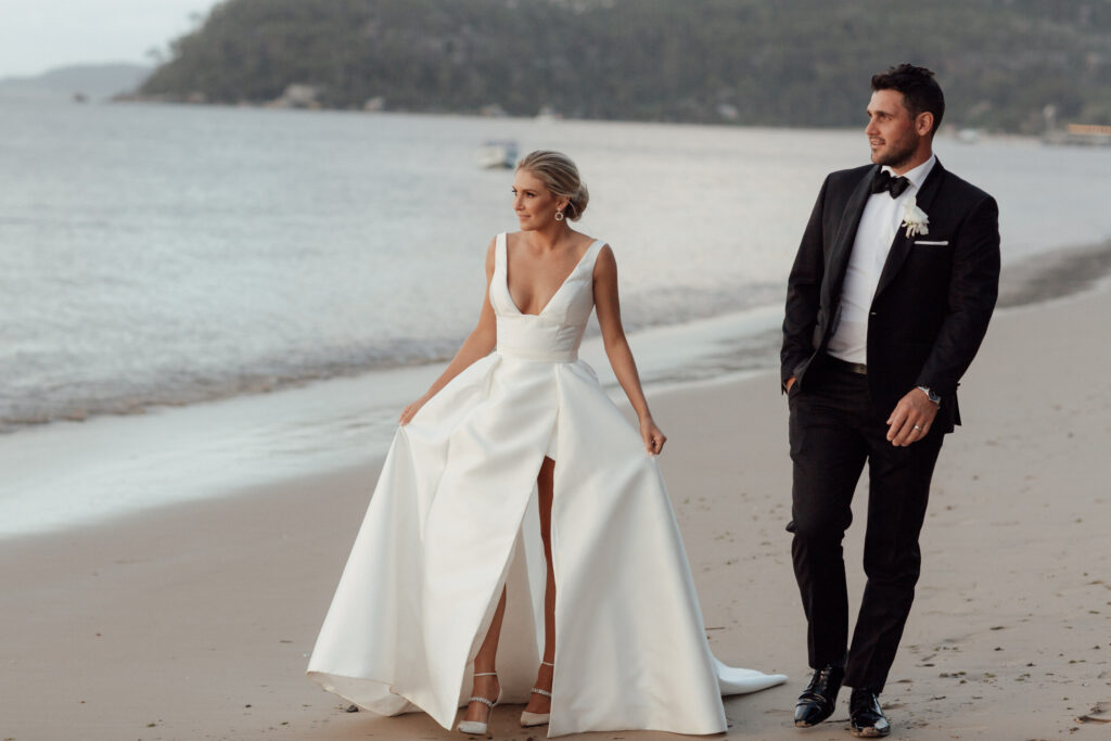 bride and groom walking at palm beach