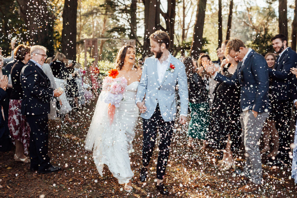 bride and groom walking with confetti