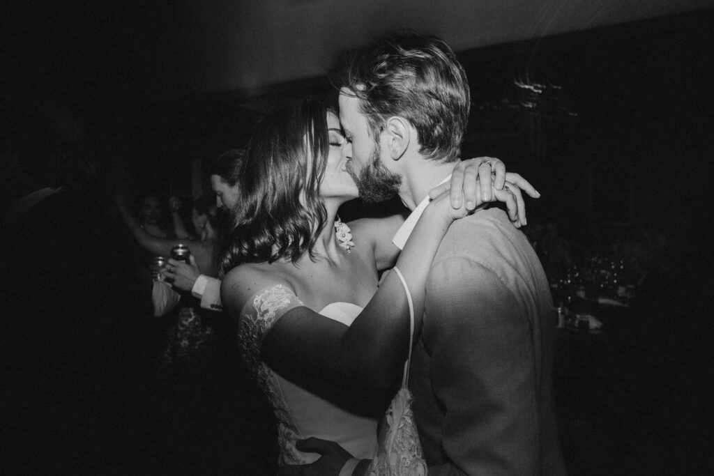 bride and groom kissing on dancefloor